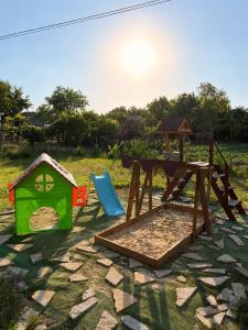 a playground with a table and a play set at Rapan Guesthouse in Bŭlgarevo