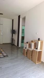 an empty room with boxes and a tv on a wall at Le Mäysa dzindzano Residence in Sada