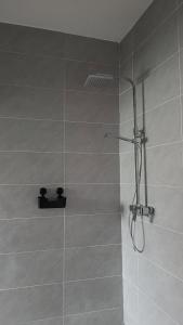 a bathroom with a shower with a shower head at Le Mäysa dzindzano Residence in Sada