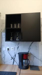 a blender sitting on a table in a kitchen at Le Mäysa dzindzano Residence in Sada +7 photos