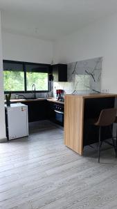 a kitchen with a counter and a sink and a stove at Le Mäysa dzindzano Residence in Sada
