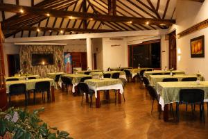 a dining room with tables and chairs in it at Hotel PUENTE PIEDRA PARK in Villa de Leyva