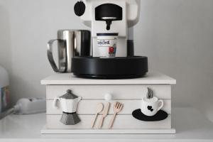a table with a coffee maker and utensils at 3Season Ortona B&B in Ortona
