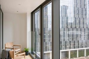 a room with large windows looking out at a city at Cove Landmark Pinnacle in London