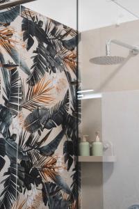a bathroom with a shower with a black and brown wallpaper at 3Season Ortona B&B in Ortona +48 photos