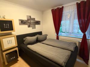 a bedroom with a bed and a tv and a window at 2 Zimmer Apartment am Europapark - auf Wunsch klimatisiert für 10,-Aufpreis pro Nacht in Rust