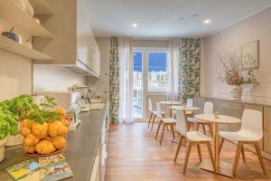 a kitchen with a table and chairs and a counter top at B&B H68 in Alassio
