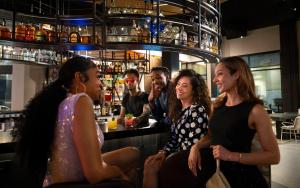 a group of people sitting at a bar at Moxy Atlanta Downtown in Atlanta