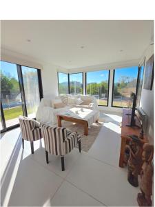 a living room with a couch and a table at COSTA ESMERALDA S3 para 10 pileta y jardín privados in Pinamar