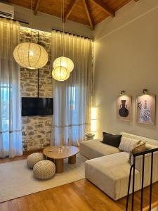a living room with a couch and a table at Nia The Nest in Nafpaktos
