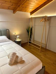 a bedroom with a bed and a wooden ceiling at Nia The Nest in Nafpaktos