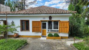 a small white house with a wooden door at Campoarique in Tudela de Duero