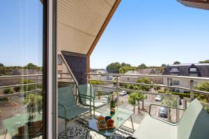 a balcony with chairs and a view of a street at Le Calmette - Balcon, Parking & Ascenseur in Caen