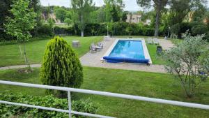 a swimming pool in a yard with a park at Campoarique in Tudela de Duero