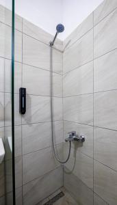 a shower with a shower head in a bathroom at B&B Sunny Side in Sarandë +63 photos