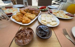 a table with plates of breakfast food on it at B&B Sunny Side in Sarandë