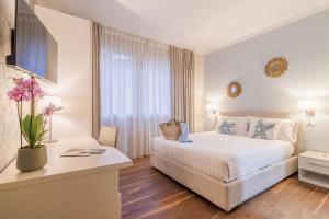 a hotel room with a bed and a window at B&B H68 in Alassio