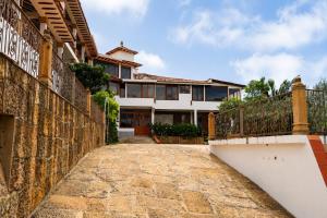 a house with a stone walkway in front of it at Hotel PUENTE PIEDRA PARK in Villa de Leyva
