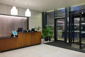 an office lobby with a desk with a computer on it at Cove Landmark Pinnacle in London