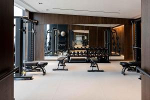 a gym with treadmills and dumbbells at Cove Landmark Pinnacle in London