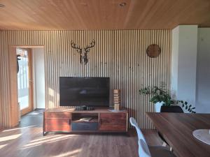a living room with a flat screen tv on a wall at Bereuter in Sibratsgfäll
