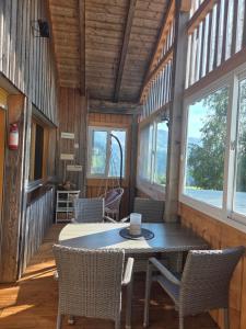 a dining room with a table and chairs in a cabin at Bereuter in Sibratsgfäll