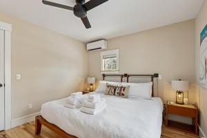 a bedroom with a bed with towels on it at Maple Chalet in Morrisville