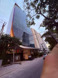 a tall glass building on the side of a street at Santamarta, marina centro historico in Santa Marta