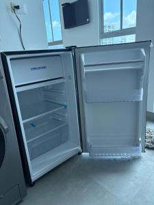 an empty refrigerator with its door open in a room at Santamarta, marina centro historico in Santa Marta