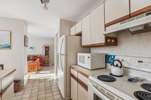 a kitchen with a stove and a refrigerator at Mountainside Condo J202 in Stowe +24 photos