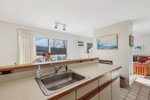 a kitchen with a sink and a counter at Mountainside Condo J202 in Stowe