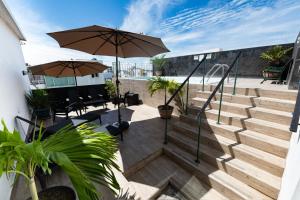 a set of stairs with a patio with an umbrella at Boca Inn Hotel & Suites in Veracruz