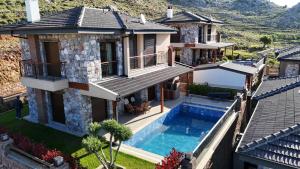 an aerial view of a house with a swimming pool at Bozburunvillas in Bozburun