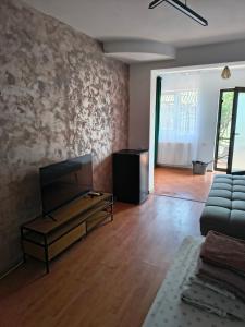 a living room with a couch and a television at Casa Cristina Corbu in Corbu