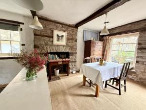a dining room with a table and a desk at Half Moon House in Hay-on-Wye