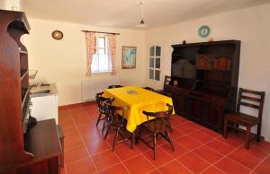 a dining room with a yellow table and chairs at Kis-Balatoni Ökoporta in Zalaszabar +10 photos