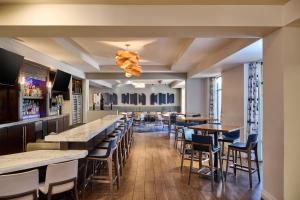 a bar with tables and chairs in a restaurant at DoubleTree by Hilton Irvine Spectrum in Irvine