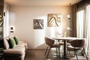 a living room with a couch and a table at Avita suites Ortisei in Ortisei