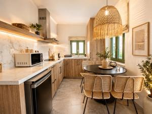 a kitchen with a table and a microwave at Casa Enetiko in Chania
