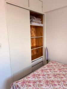 a small bedroom with a bed and a closet at Flat em Sao Jose da Coroa Grande in São José da Coroa Grande +4 photos