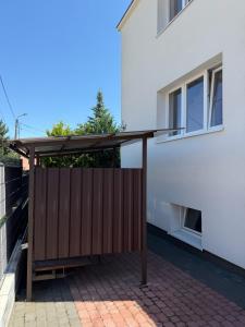 a patio with awning next to a white building at Górna Residence&Rooms in Grudziądz