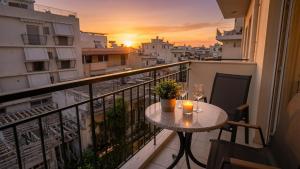 a table on a balcony with a view of a city at Kalamata Penthouse By PAVLOS in Kalamata