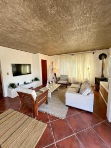 a living room with a couch and a table at Hotel Green en Marbella in Maitencillo