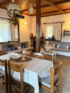 a dining room with a table and chairs and a couch at Fisherman's Cove Epanomi in Epanomi
