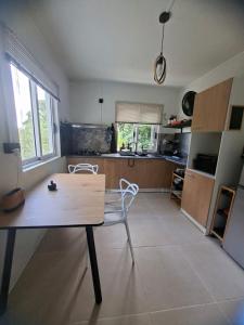 a kitchen with a table and chairs in a room at Kot Ory Mountain View Studio in Moka