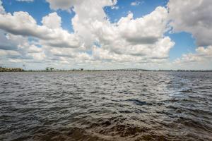 a large body of water with a cloudy sky at Little EsCape in Matlacha