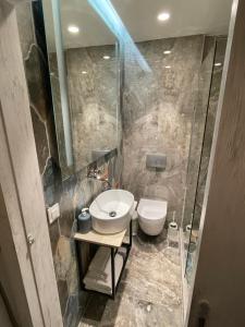 a bathroom with a sink and a toilet at Dionisia apartments in Kos +24 photos