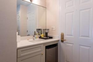 a bathroom with a sink and a mirror at The Meadowmere Resort in Ogunquit