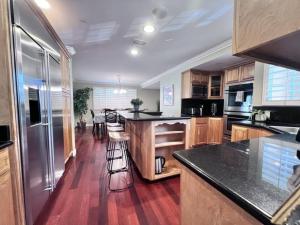 a kitchen with wooden floors and a counter top at Amazing Large Family Home w/Pool, 1 Mile to Disney in Anaheim