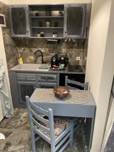 a small table and chairs in a small kitchen at Dionisia apartments in Kos